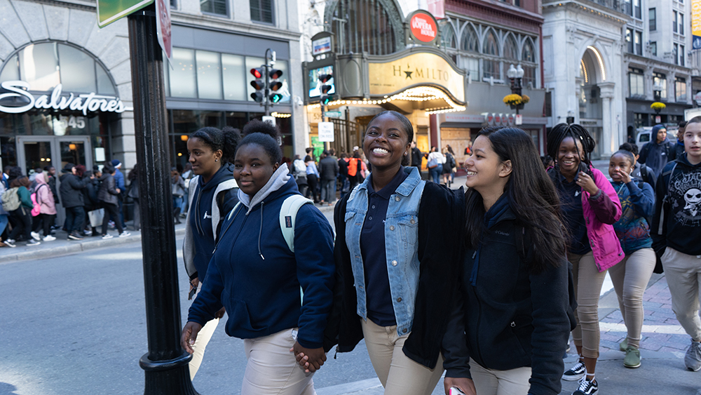 Young women walking to Boston Opera House to see Hamilton
