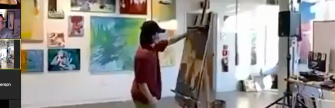 Person painting a canvas in a studio